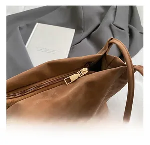 Close-up of premium golden metal zipper detail on brown vintage leopard bucket bag