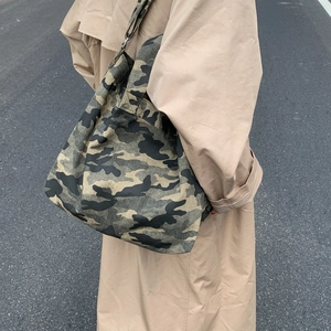 Detailed view of the jungle camouflage canvas tote bag with adjustable shoulder strap