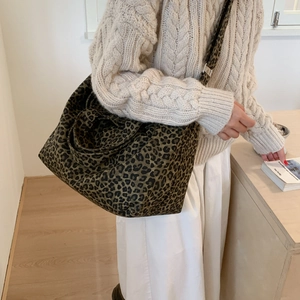 Detail view of large leopard print canvas tote bag with adjustable shoulder strap