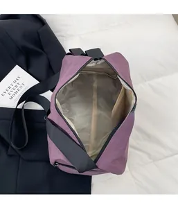Interior view of purple nylon messenger bag showing zipper pocket and spacious main storage