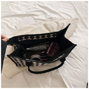 Top view of spacious checkerboard tote bag interior holding umbrella and pouches