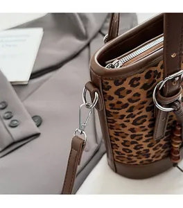 Details des silbernen Metallreißverschlusses und der Beschläge der Leoparden-Beuteltasche