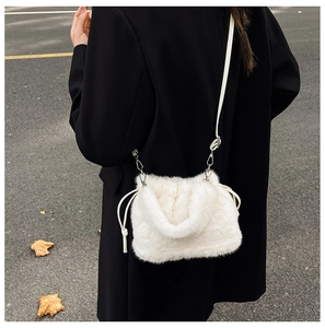 White fluffy plush crossbody bucket bag with drawstring detail shown on model back