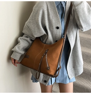 Retro brown large tote bag styled as a crossbody bag with slouchy leather details