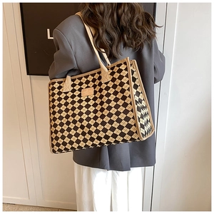 Close-up of Large canvas tote bag with brown checkered pattern and leather patch