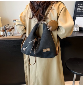 Detail of black matte tote with brown round pouch and Fashion & Bags leather label