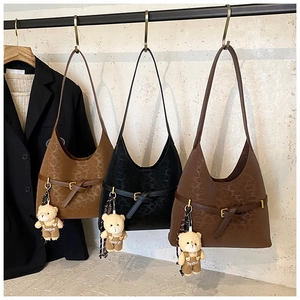 Detail of leopard print tote bags with metal buckles and cute fashion bear charms