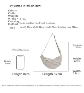 Detailed view of beige canvas crescent bag with dimensions and phone size comparison