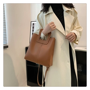 Brown PU leather tote bag featuring a cutout handle and stylish longitudinal stitching detail