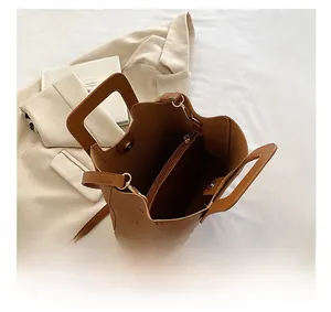 Internal view of brown leather bucket bag showing large capacity and multi-layer structure