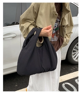 Detailed view of black puffy cloud tote bag made of soft fabric for daily casual use