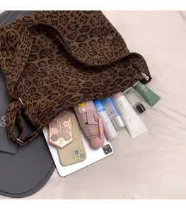 Spacious leopard print tote bag interior showing capacity for tablet and cosmetics