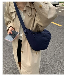 Detail of navy blue crescent nylon bag with adjustable strap in street style