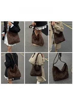 Detail of hobo bag with leopard print, wide shoulder strap and gold adjustable buckle