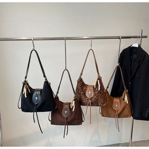 Vue détaillée de quatre sacs hobo en daim bohème avec franges et boucle en métal