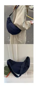 Detail of navy blue nylon crescent bag with adjustable strap and textured surface