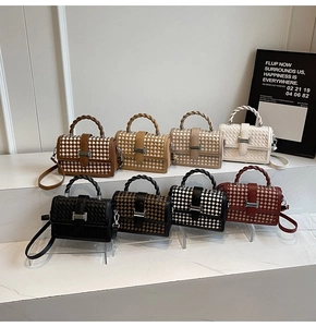 Close-up of woven checkered texture and twisted handles on versatile small square bags