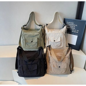 Detail view of multi-pocket nylon tote bags in four versatile colors and adjustable straps