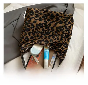 Detailed interior view of a leopard print tote bag showing capacity for a tablet and phone