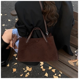 Brown frosted suede tote bag shown in an autumn outdoor setting on a wooden bench