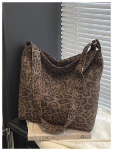 Detail of leopard print hobo bag with adjustable strap on a white studio background