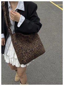 Detail shot of a large leopard print tote bag with adjustable wide shoulder strap