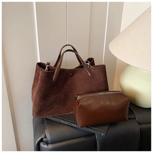 Deep brown matte suede tote bag with matching zipper pouch on a black surface