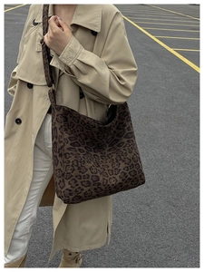 Outdoor street shot of large leopard print tote bag with stylish wide shoulder strap