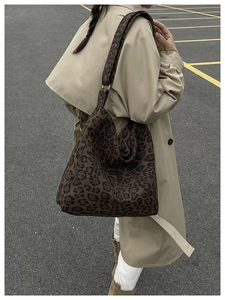 Detail of leopard print tote bag with wide shoulder strap and gold metal ring link
