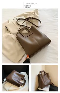 Detail view of coffee brown leather tote with unique square cutout handle and stitching