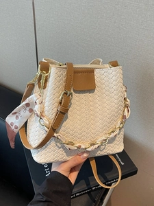 Chic woven bucket bag in cream white with brown leather trim and scarf handle
