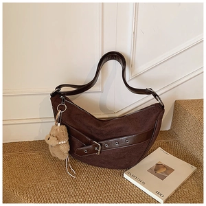 Detail of dark brown leopard suede hobo bag with metal buckle and plush puppy charm