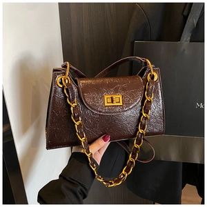 Detail of vintage brown oil wax leather shoulder bag with golden rectangle twist lock