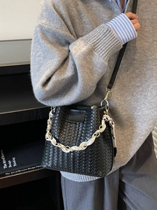 Retro black woven leather bucket bag with gold chain and silk scarf detail