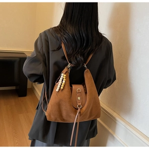 Brown vintage frosted leather tote bag shown as a backpack with colorful bead charms
