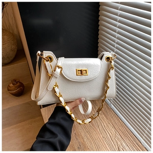 Detail of white wrinkled leather handbag featuring a golden square twist lock and chain strap