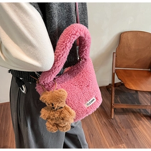Détail du sac seau rose en peluche avec texture douce et breloque ours en peluche marron
