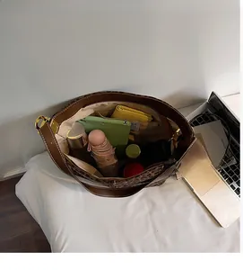 Spacious interior of leopard print tote bag holding a tablet, umbrella, and essentials