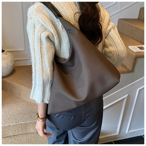 Close-up of large coffee brown nylon crossbody bag with wide strap for daily commute