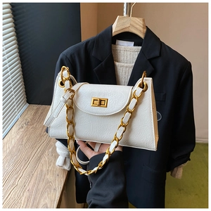 Close-up of white wrinkled leather bag with chunky gold chain and metallic turn-lock