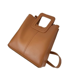 Brown vintage faux leather tote bag with square cutout handles and adjustable shoulder strap