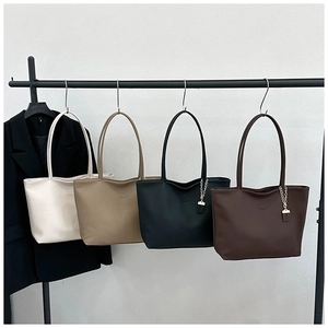 Row of minimalist textured faux leather tote bags in four neutral colors for work