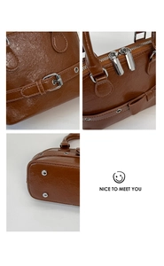 Close-up of brown shell bag showing oily leather texture, metal zipper and bow detail
