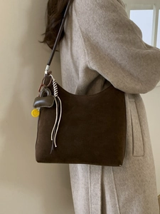 Large dark brown suede tote bag with woven fringe and yellow smiley face charm