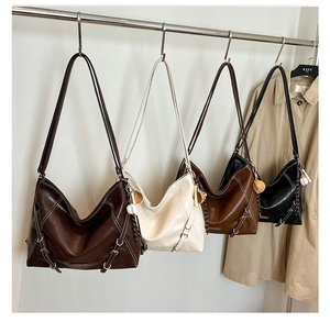 Macro shot of vintage tote backpacks in four colors with contrast stitching and baseball charm