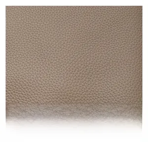 Close-up of the premium beige lychee pattern leather texture on a spacious tote bag