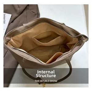 Top view showing internal structure of minimalist leather tote bag with zipper pockets