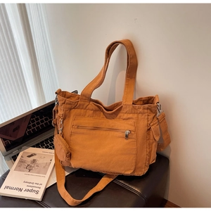 Orange-brown canvas tote bag with small matching pouch and adjustable shoulder strap