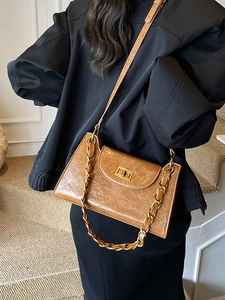 Caramel pleated leather crossbody bag with gold chain and metal turn-lock closure