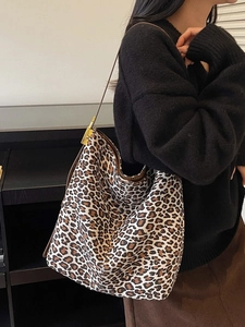 Vintage leopard print hobo bag with large capacity and gold buckles on a female model